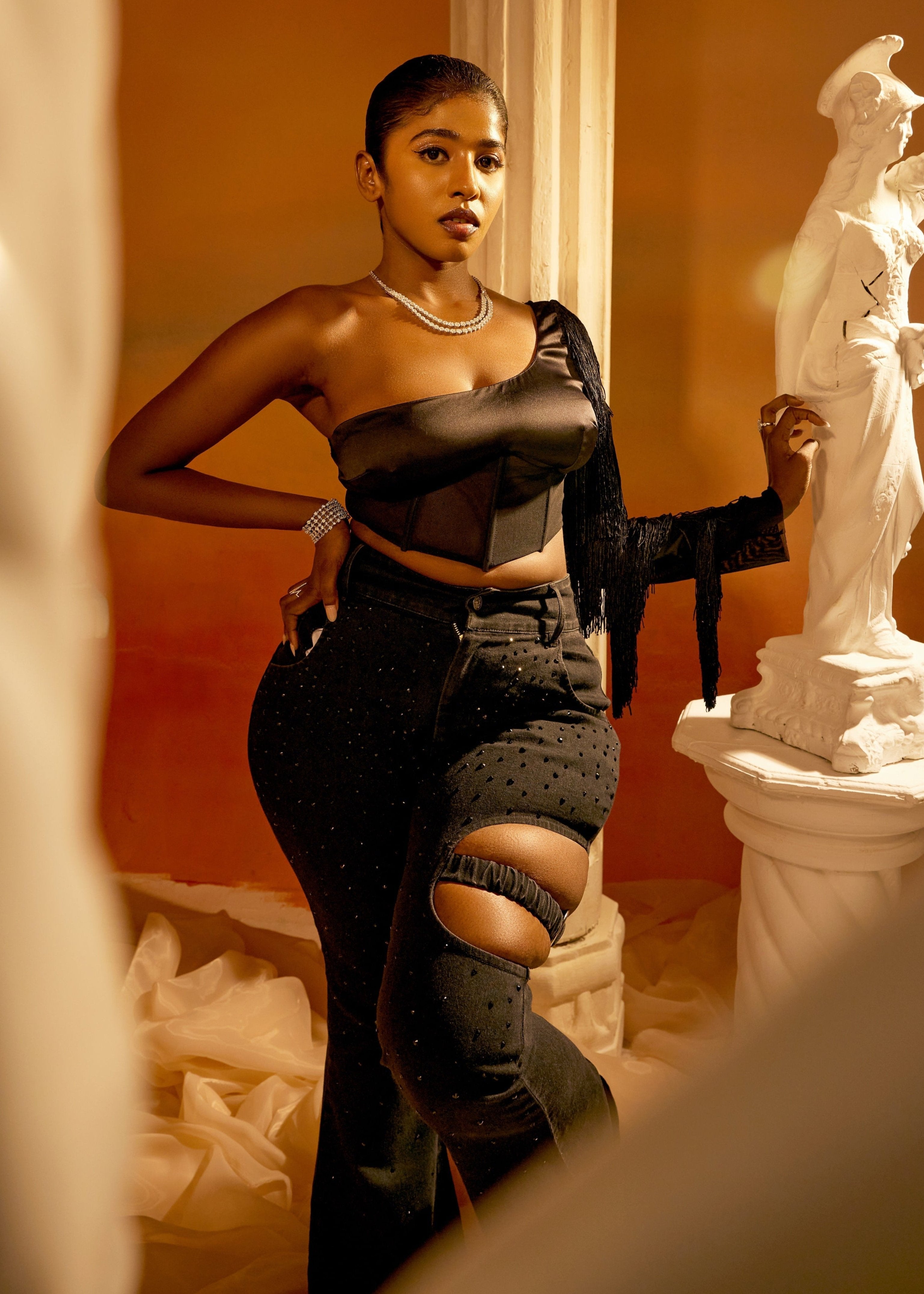 Arabella Black Tassel Sleeve Corset featuring dramatic tassel sleeves and a structured corset design in black