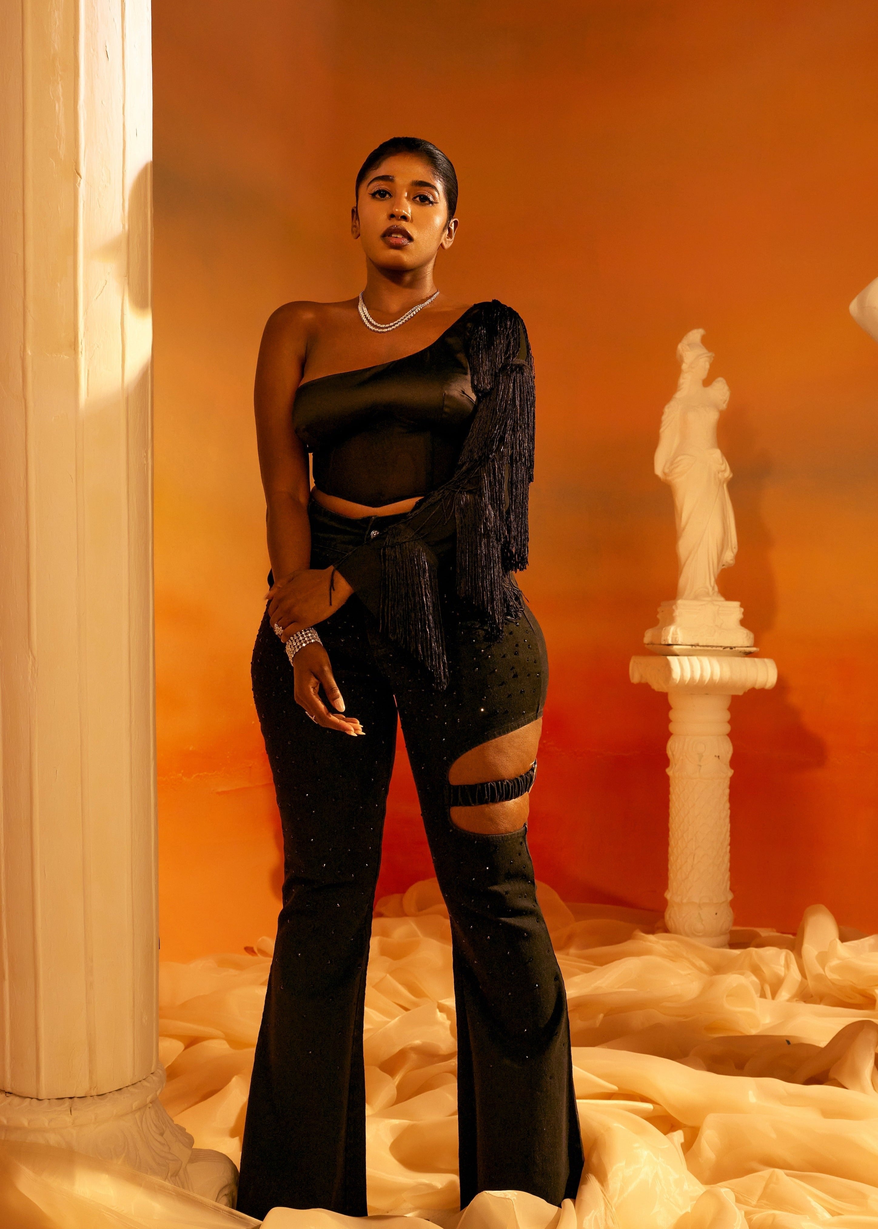 Arabella Black Tassel Sleeve Corset featuring dramatic tassel sleeves and a structured corset design in black