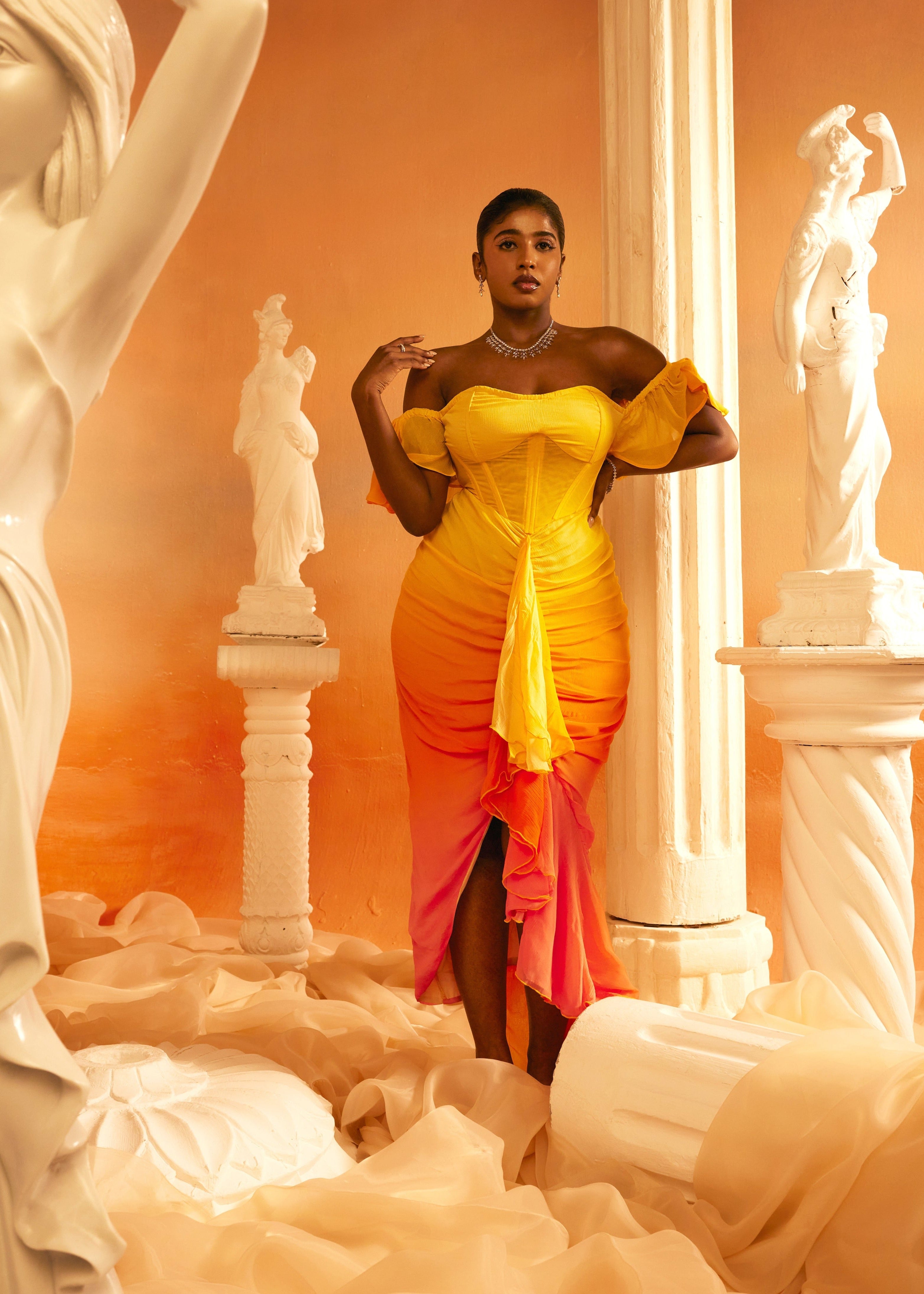 Greta Sunset Ombre Chiffon Corset Dress featuring a flowing chiffon fabric with a stunning sunset ombre gradient and a structured corset bodice