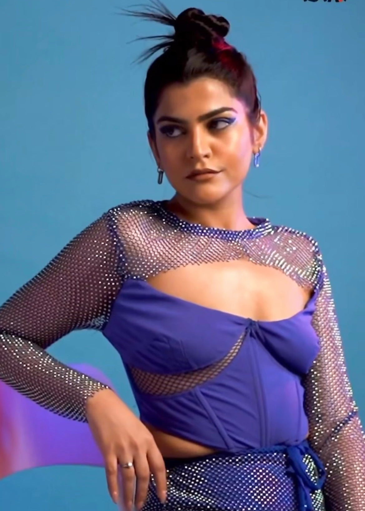 Blue crystal mesh mini skirt with a shimmering, transparent fabric and a fitted design