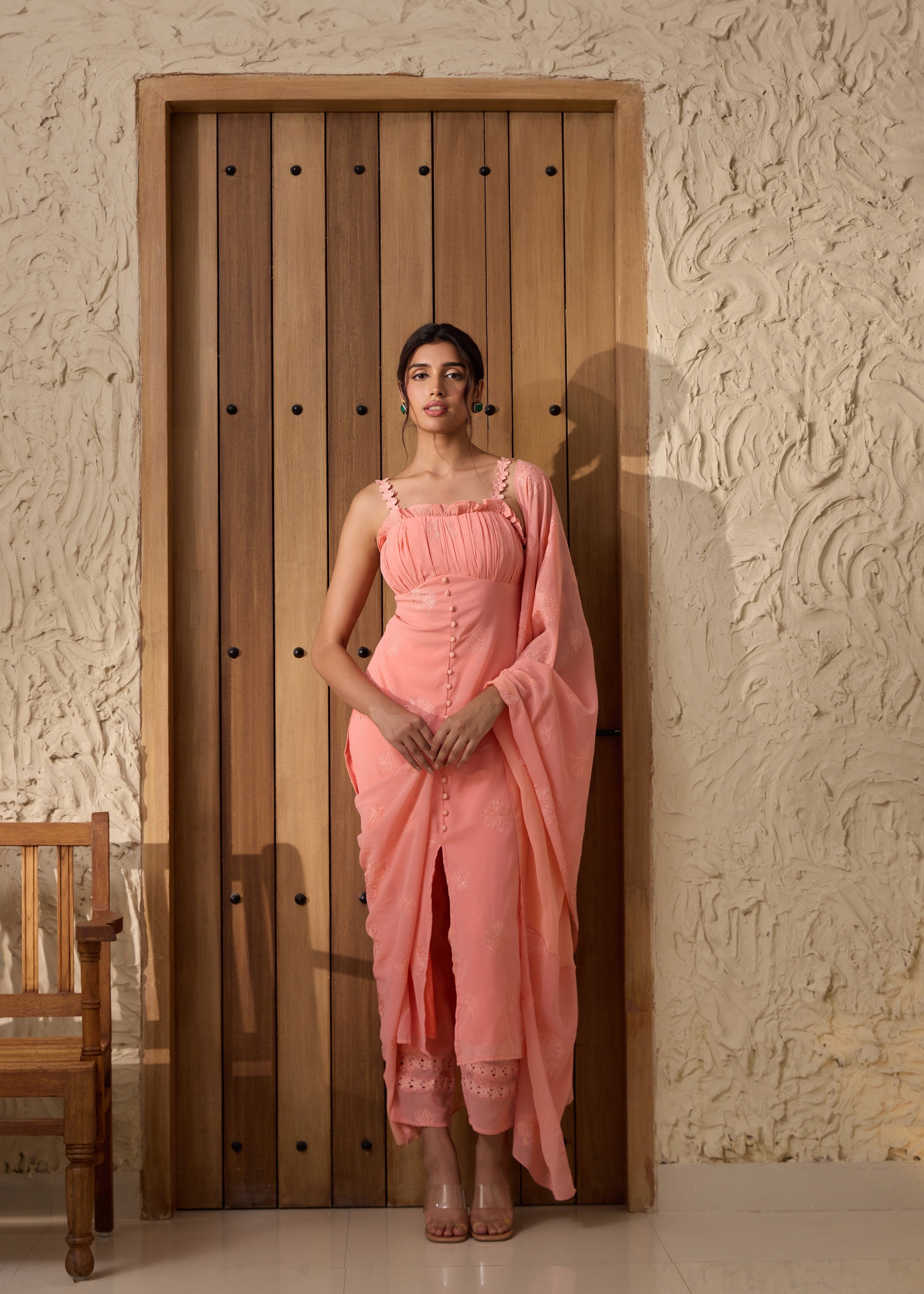 A pink georgette kurta set with intricate embroidery.