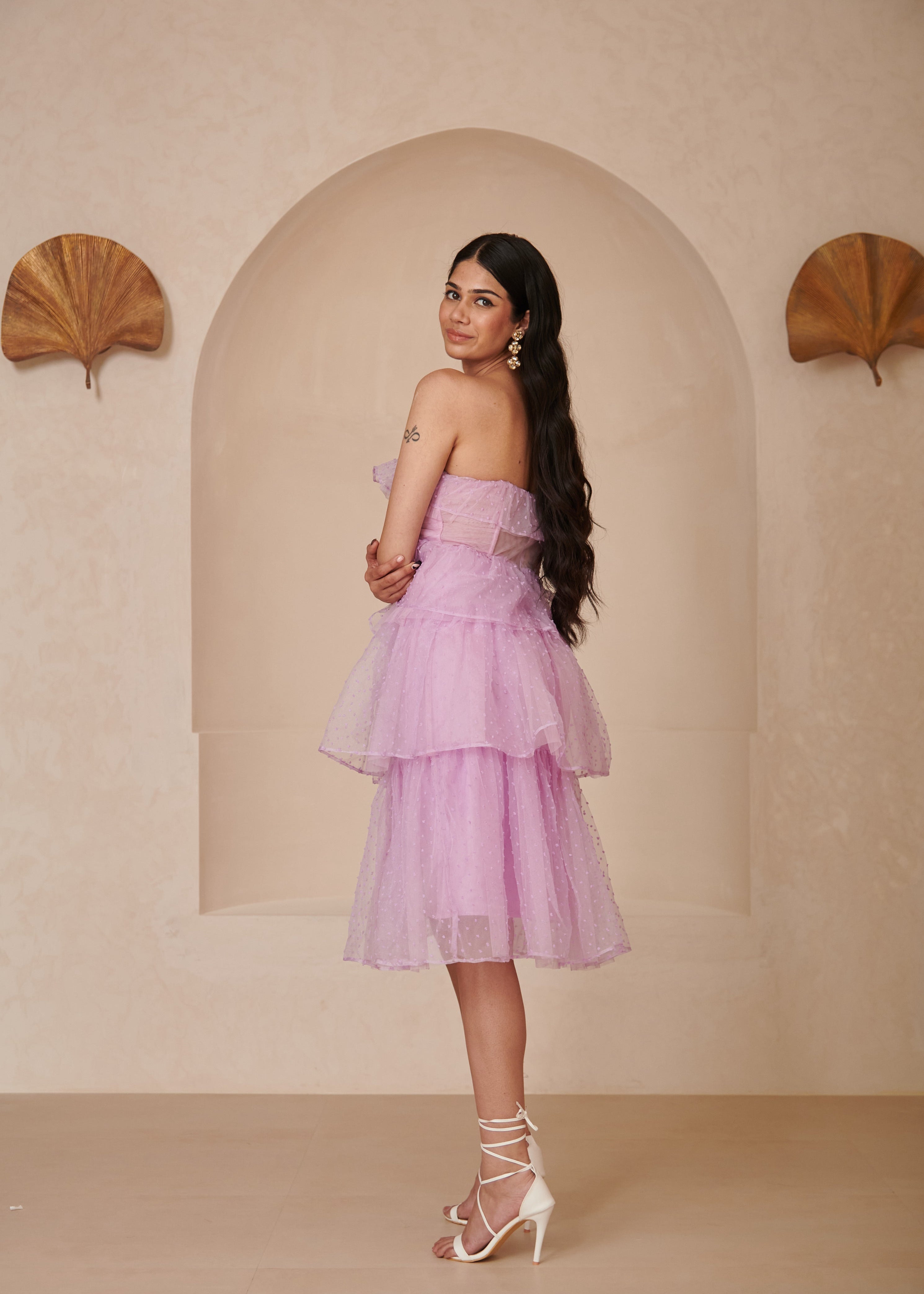Stylish woman in a Florine Purple Organza Bandeau Corset Dress, showcasing ethereal elegance