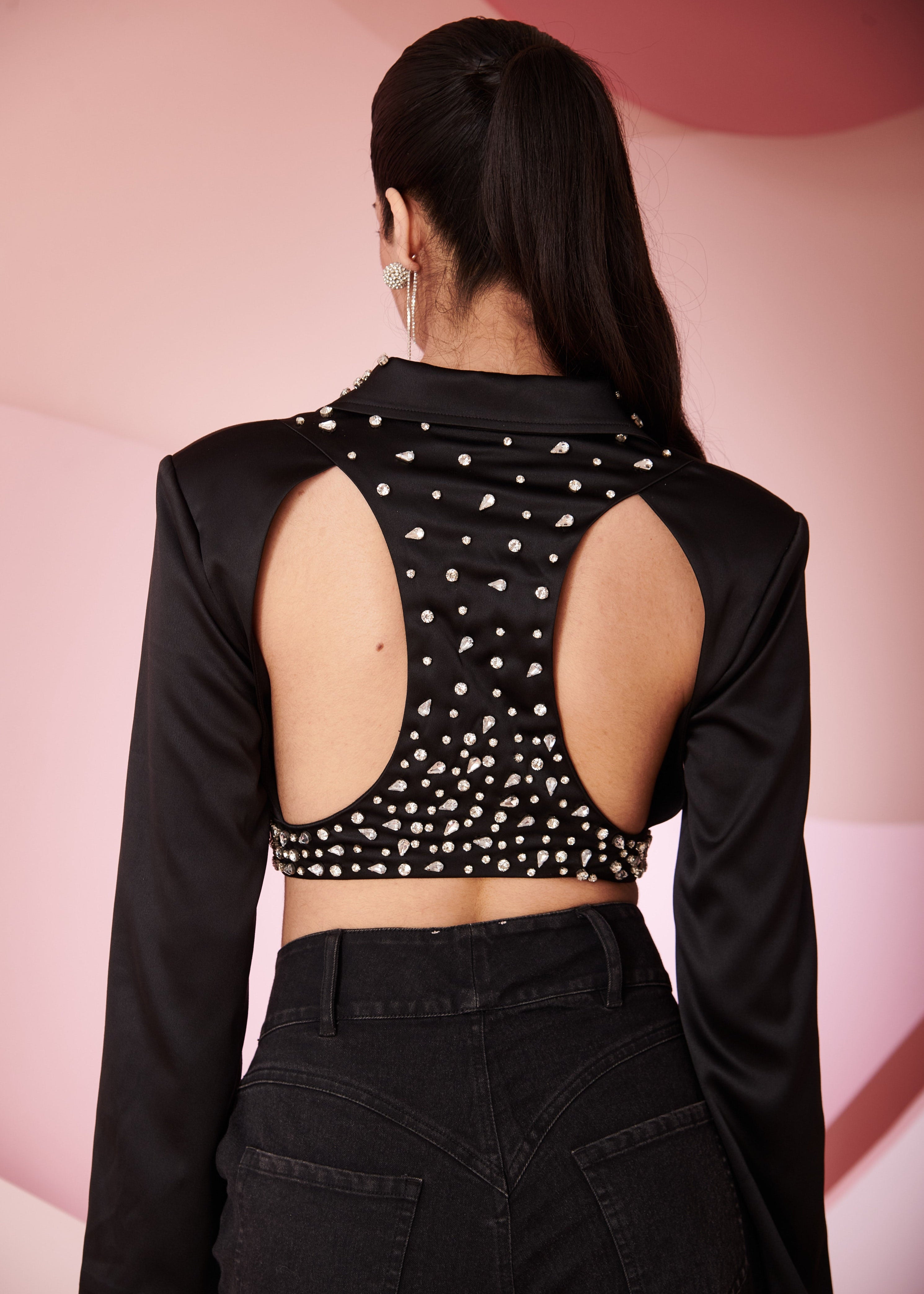 Fashion-forward woman in a Mila Black Satin Crop Jacket, showcasing sleek and modern style