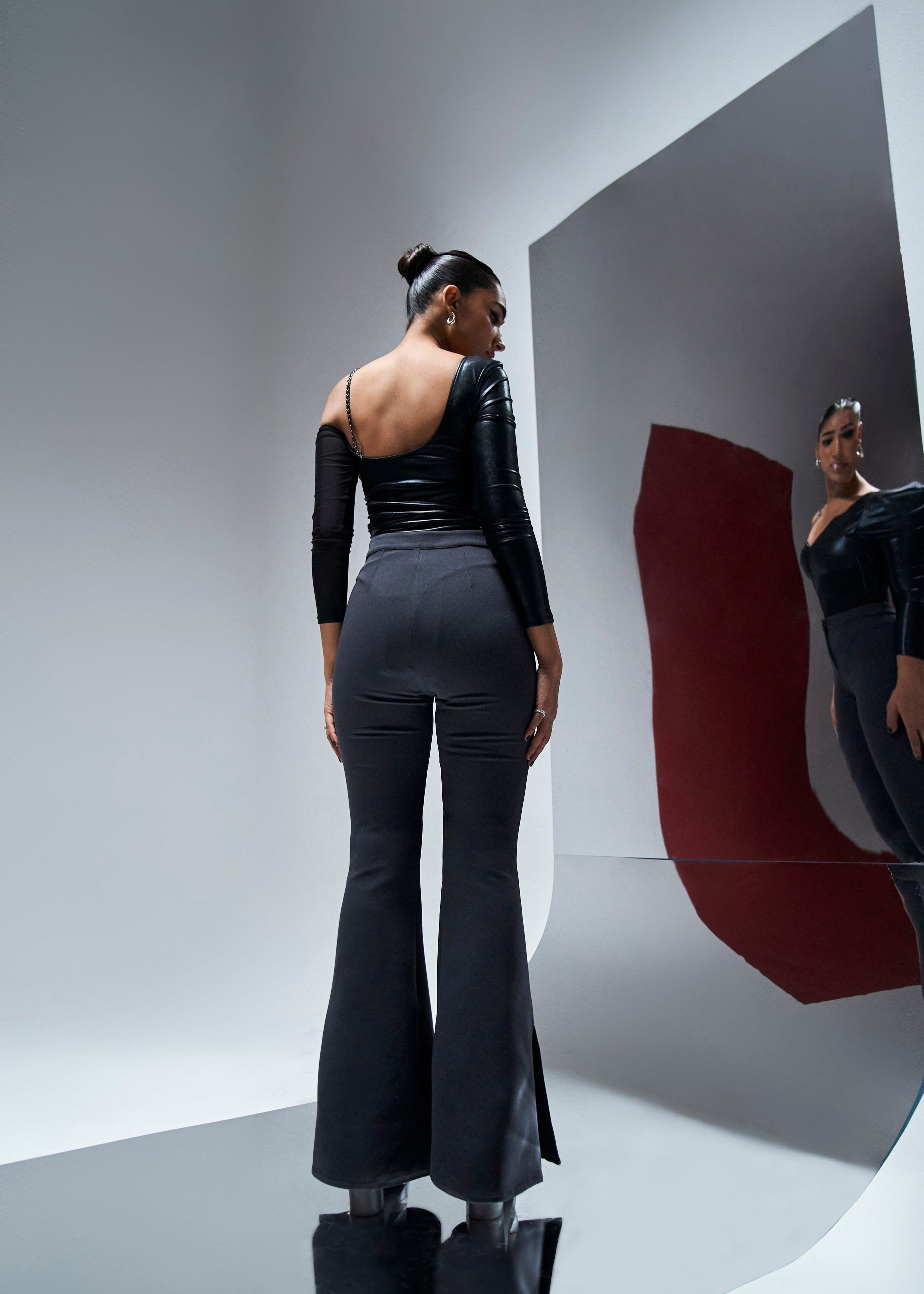 Nicolette coord set featuring a black shine bodysuit and grey flare slit pants for a chic and edgy look