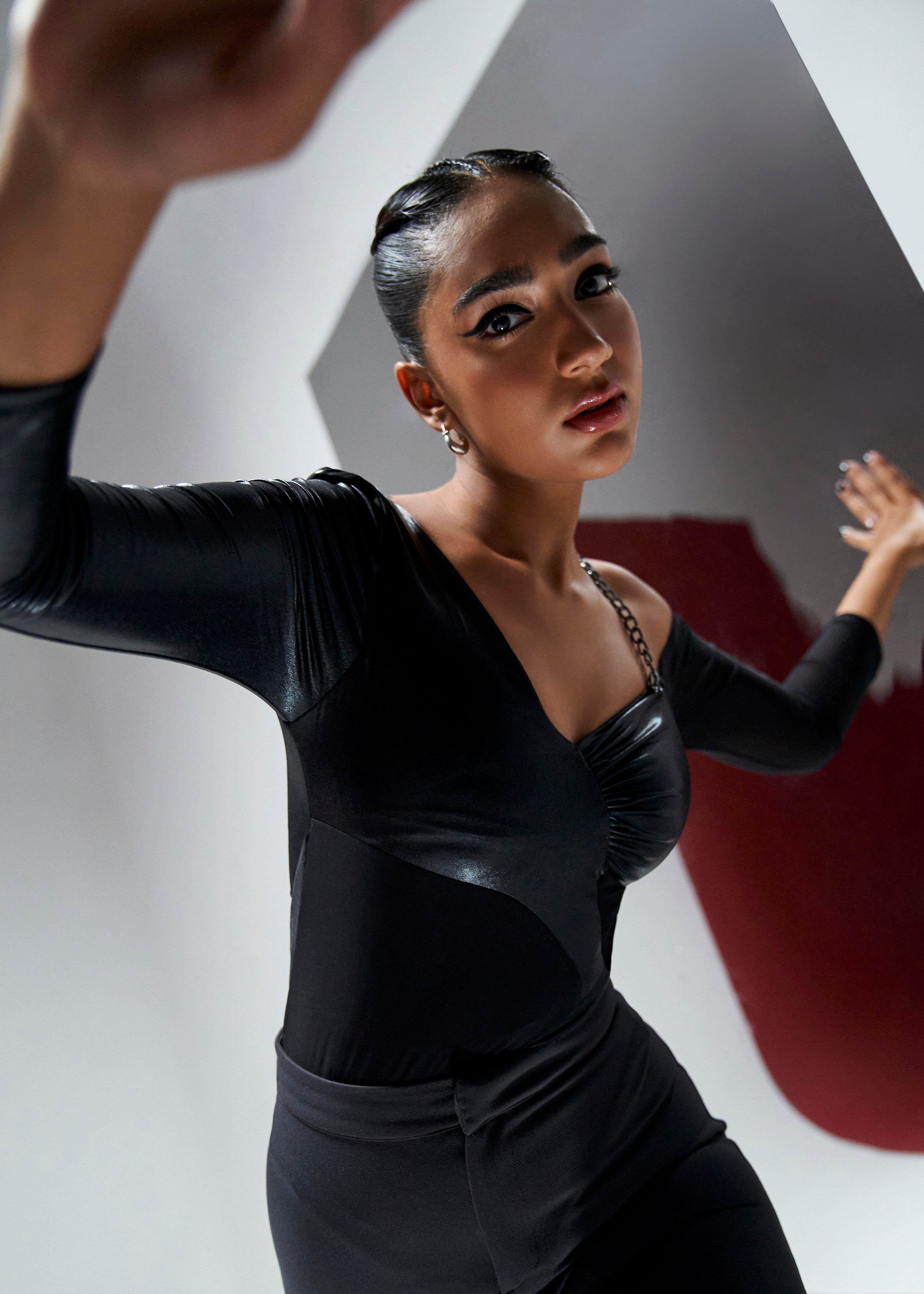 Nicolette coord set featuring a black shine bodysuit and grey flare slit pants for a chic and edgy look