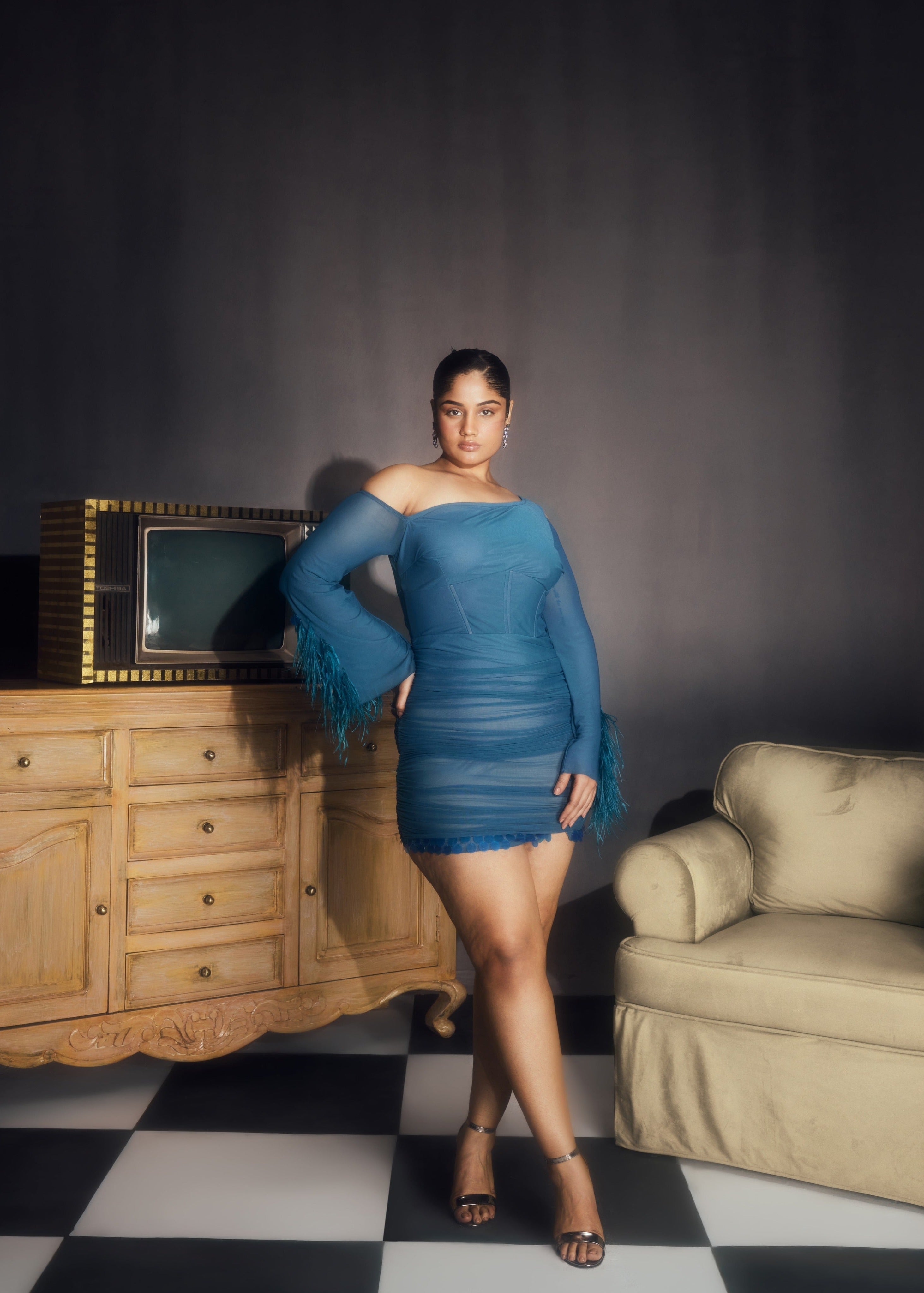 Peyton Teal Ruched Power Mesh Feather Embellished Corset Mini Dress, showcasing dramatic feathers and a flattering corset fit