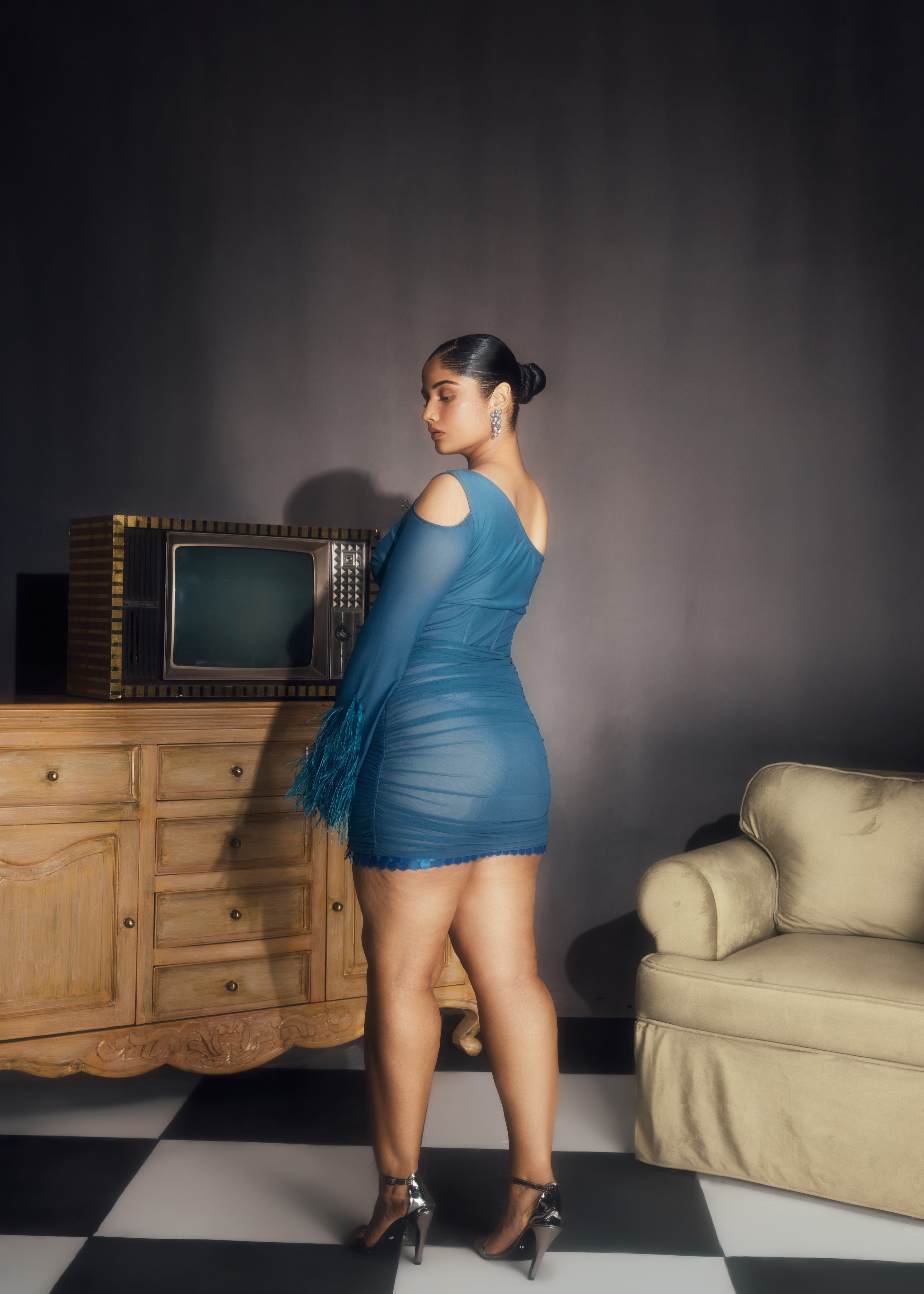 Peyton Teal Ruched Power Mesh Feather Embellished Corset Mini Dress, showcasing dramatic feathers and a flattering corset fit