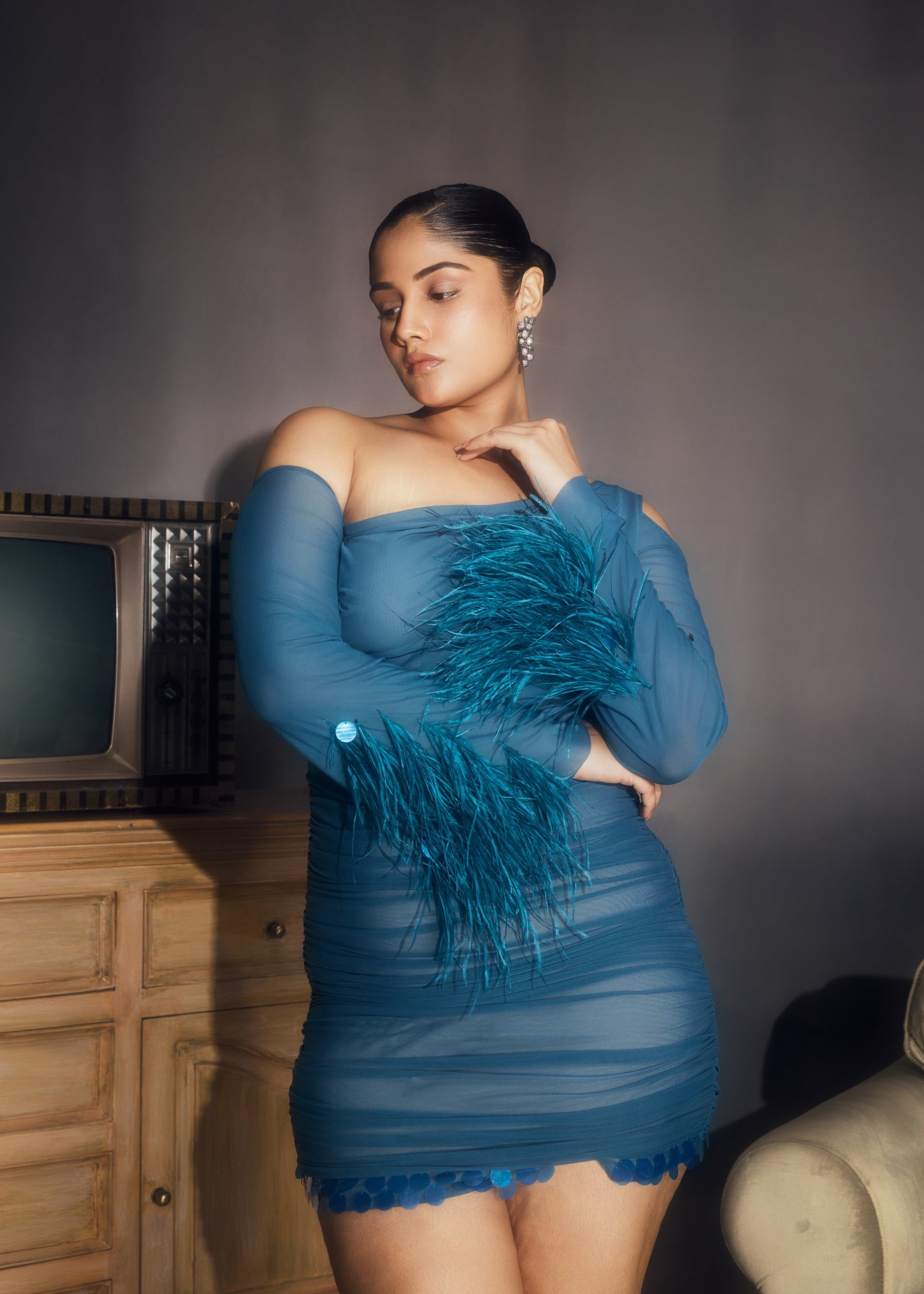 Peyton Teal Ruched Power Mesh Feather Embellished Corset Mini Dress, showcasing dramatic feathers and a flattering corset fit