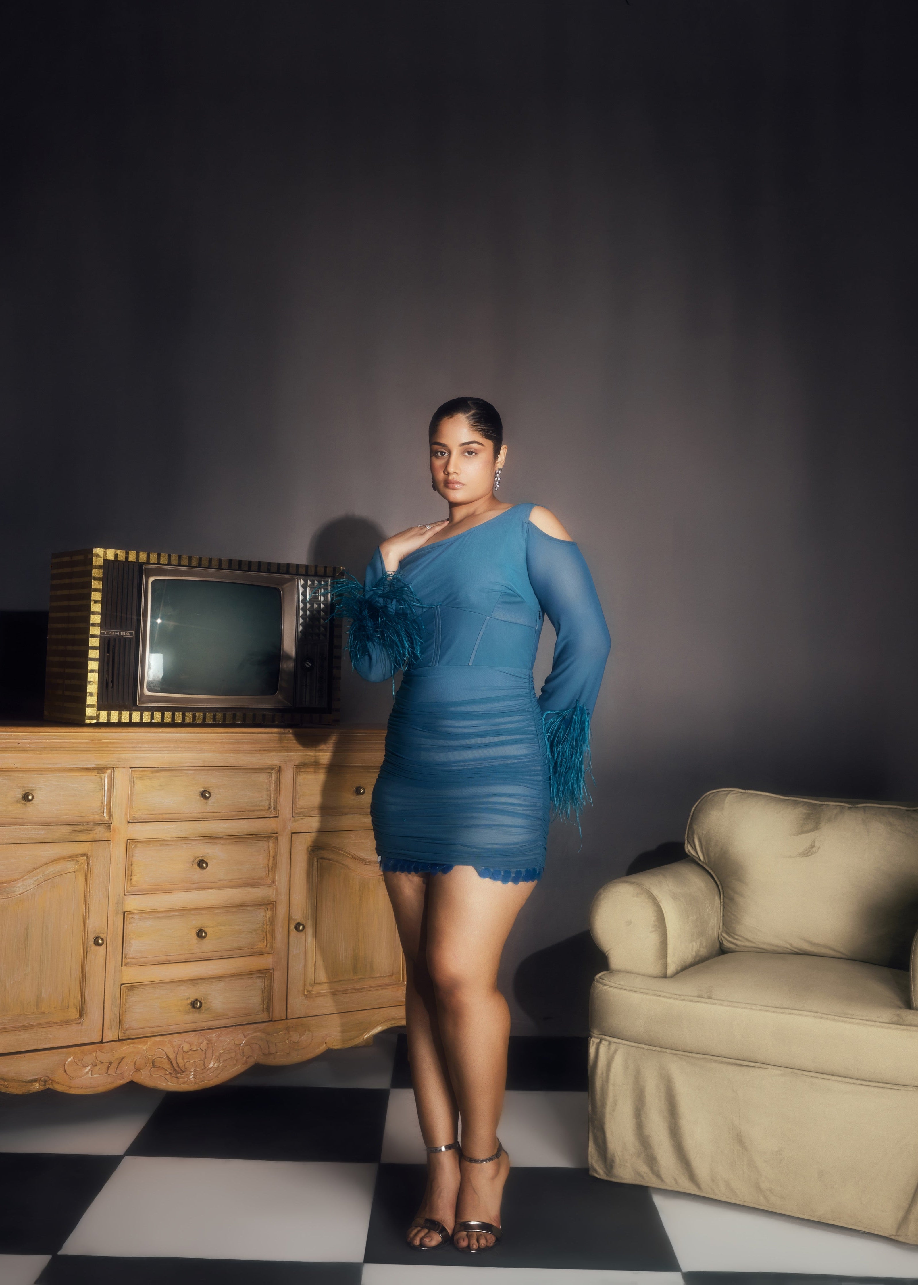 Peyton Teal Ruched Power Mesh Feather Embellished Corset Mini Dress, showcasing dramatic feathers and a flattering corset fit