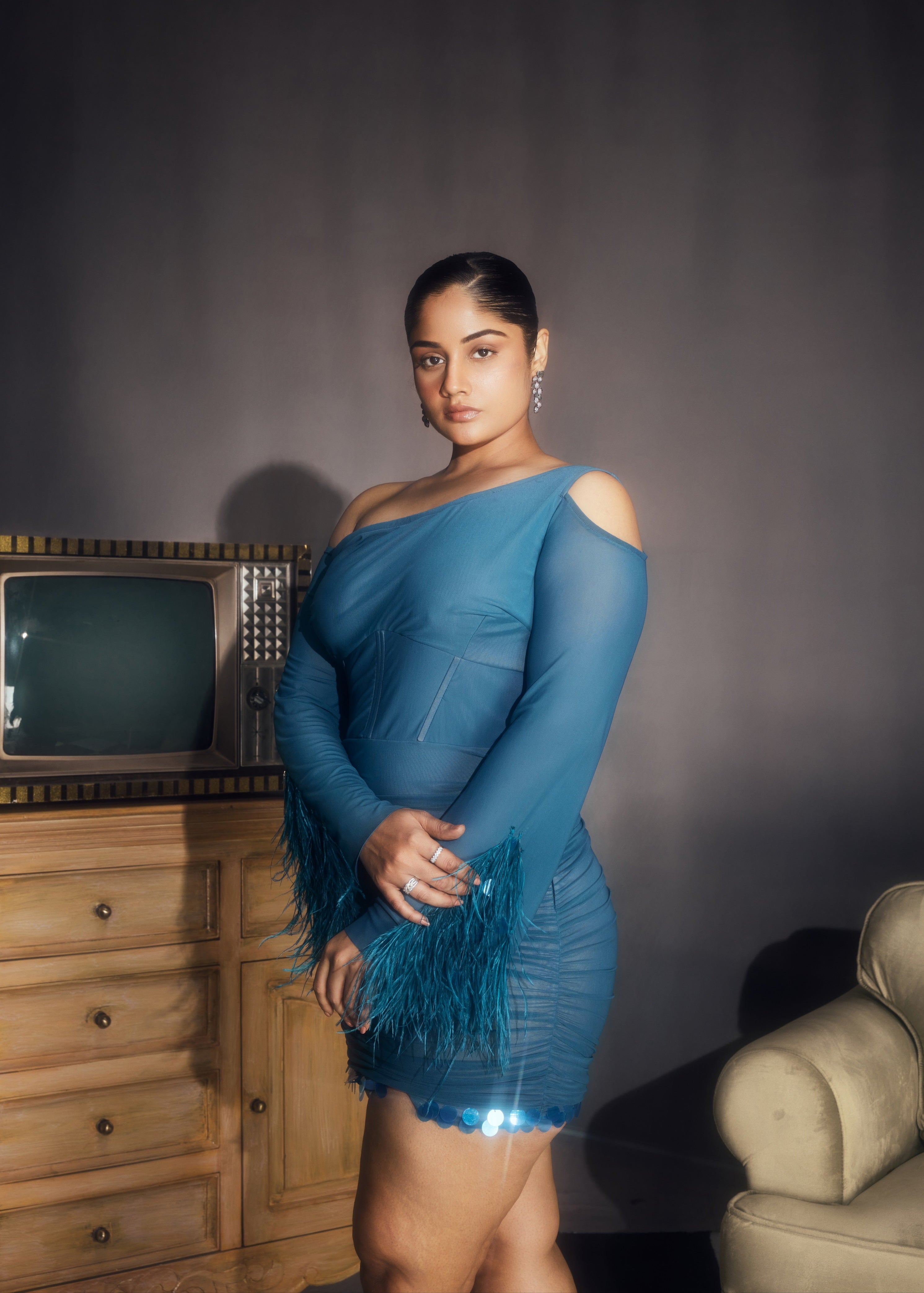 Peyton Teal Ruched Power Mesh Feather Embellished Corset Mini Dress, showcasing dramatic feathers and a flattering corset fit