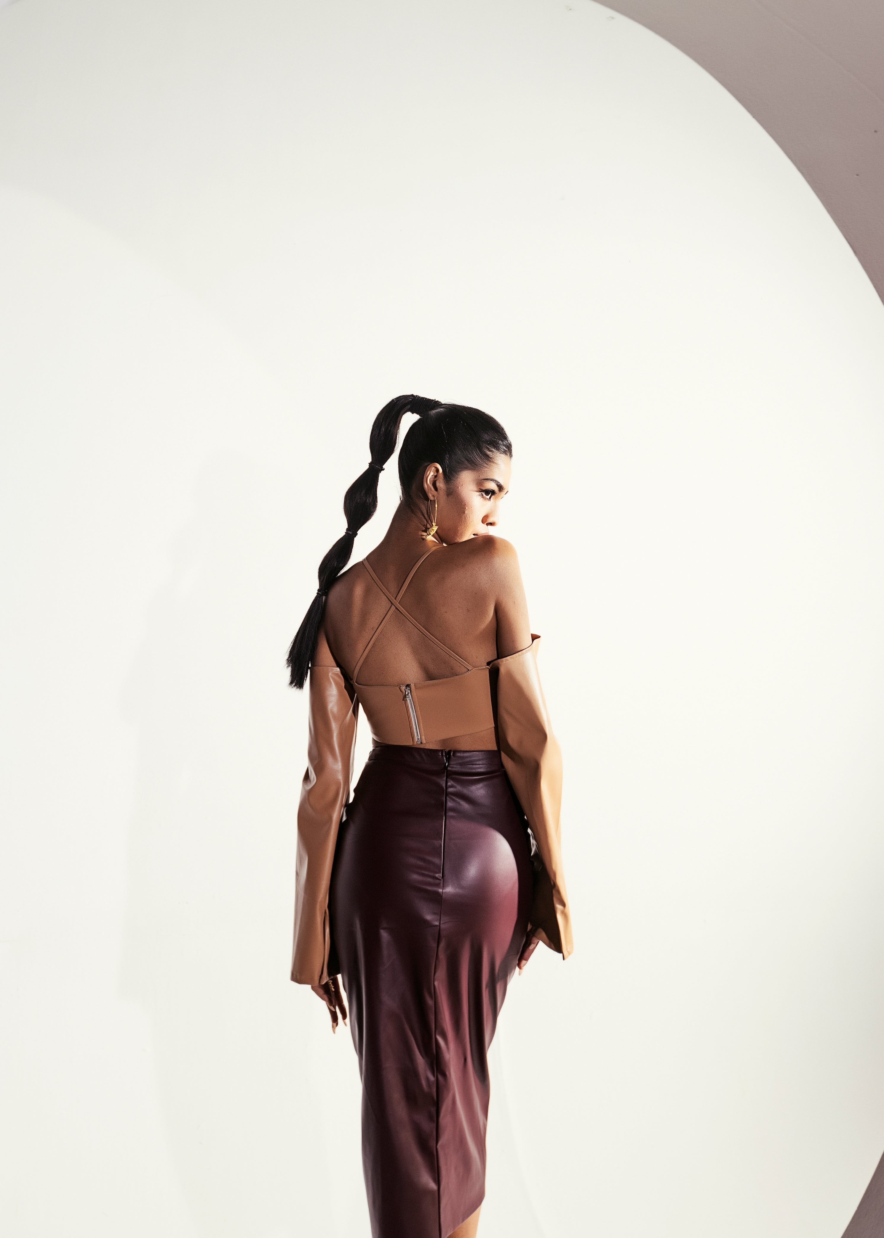 Faux leather skirt set with a fitted top and matching skirt in a cherry red hue