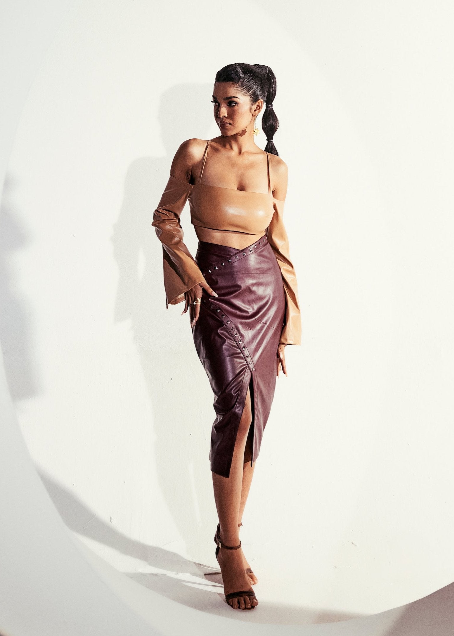 Faux leather skirt set with a fitted top and matching skirt in a cherry red hue