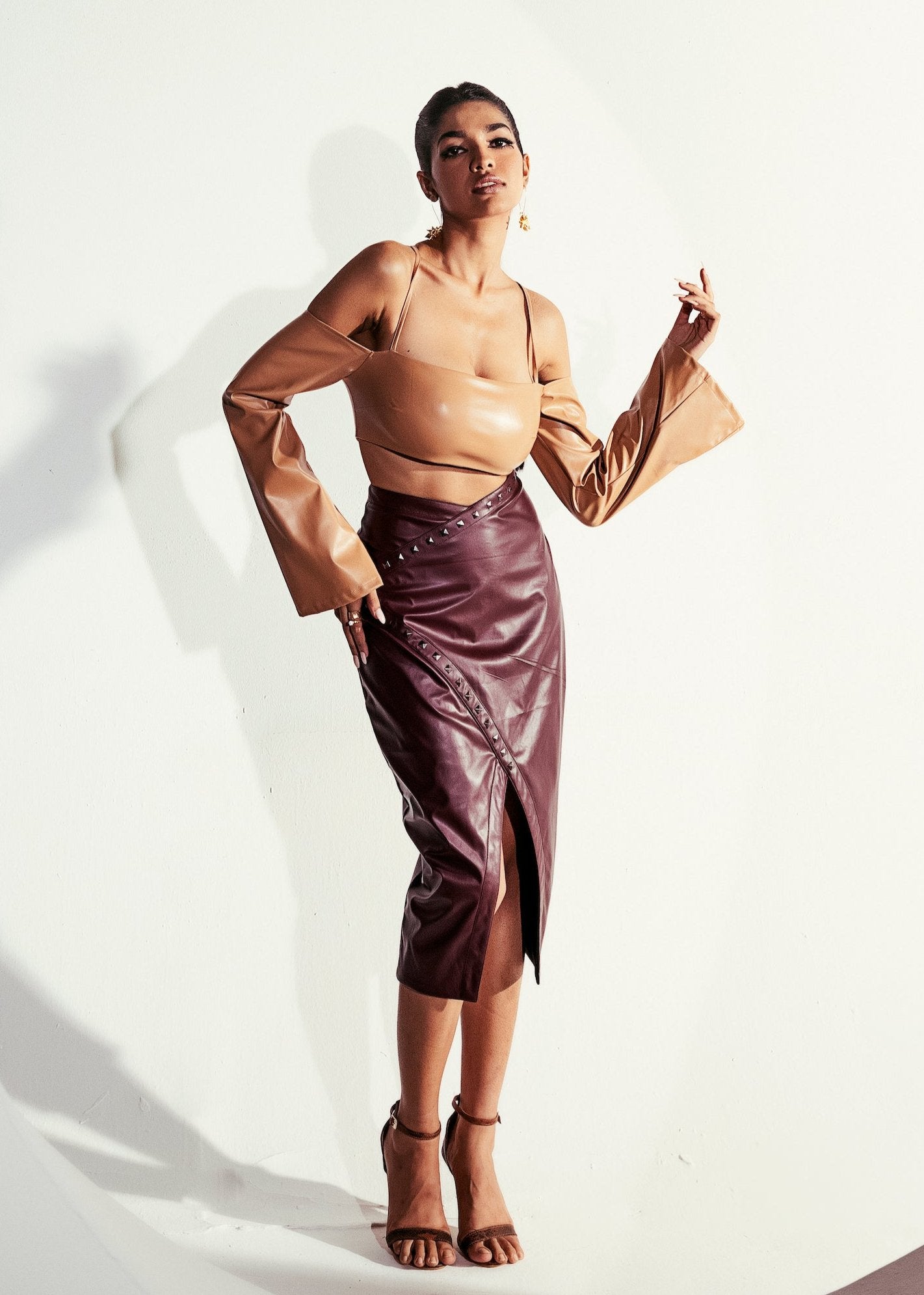 Faux leather skirt set with a fitted top and matching skirt in a cherry red hue